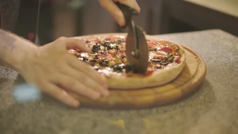 chef preparing pizza toppings in a restaurant kitchen