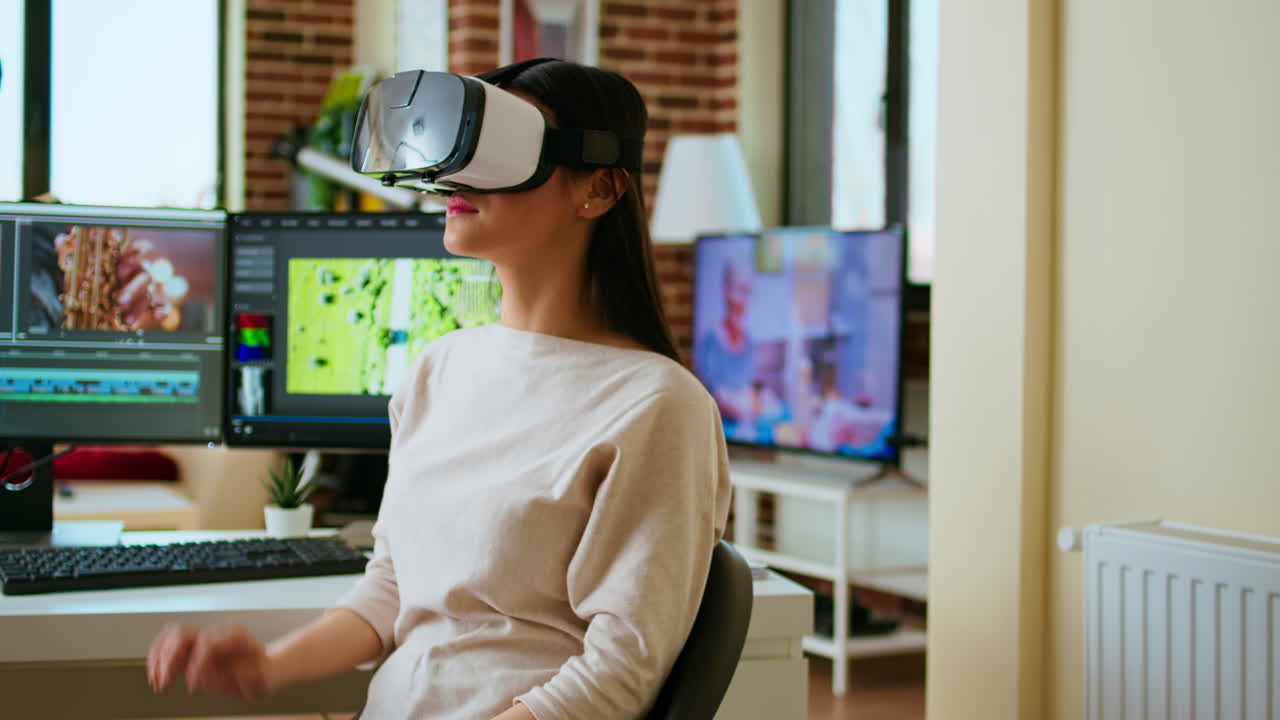 Asian woman video creator uses virtual reality headset at her desk