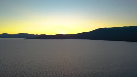 lake chelan, washington beautiful lake sunset with water and mountain silhouette in the background of recreation area