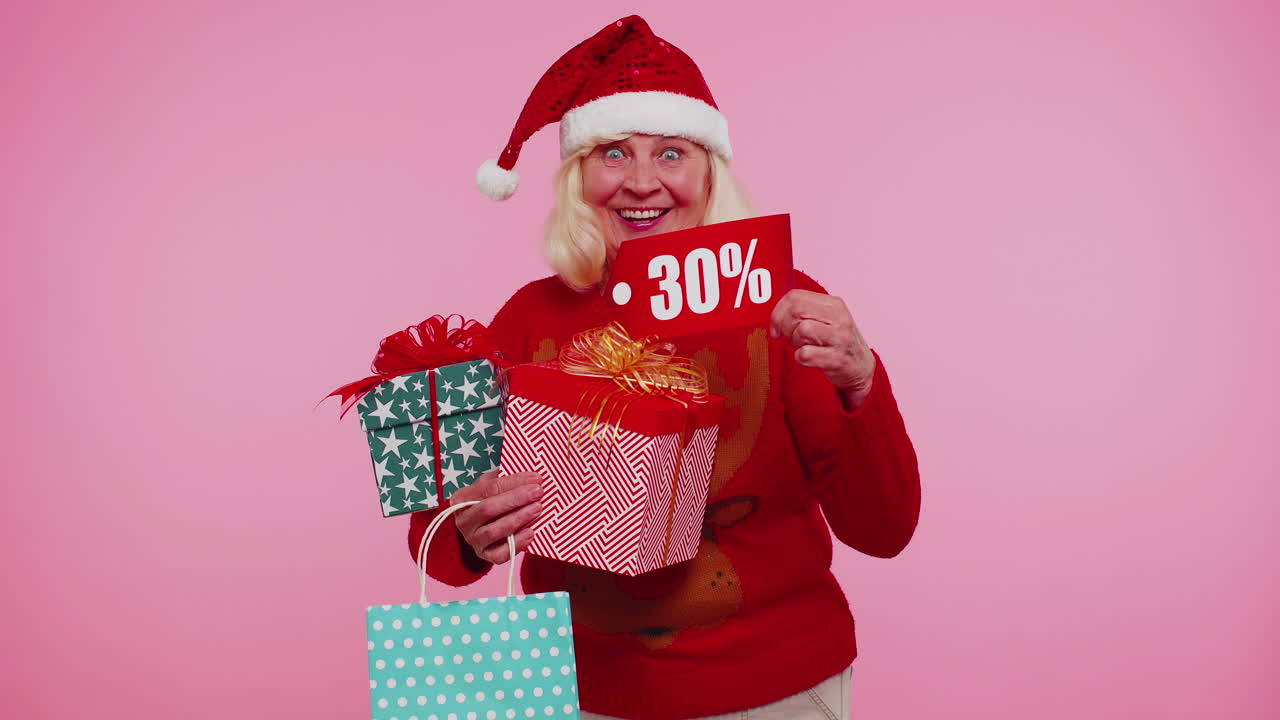 mujer mayor en suéter de navidad mostrando caja de regalos y 30 por ciento de descuento inscripciones texto de pancarta