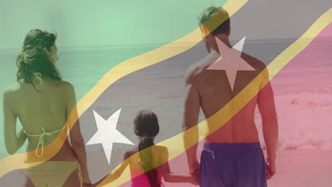 familie hält sich am strand über saint kitts und nevis an.