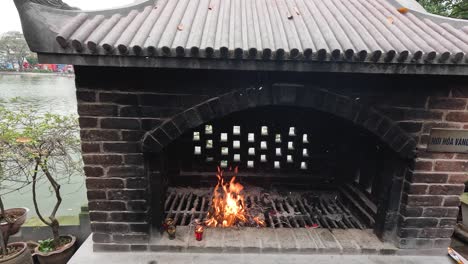 quemando papel de joss en un horno de ladrillo