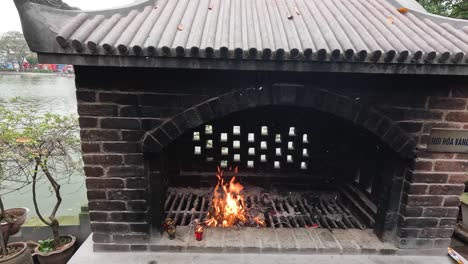 burning joss paper in a brick furnace