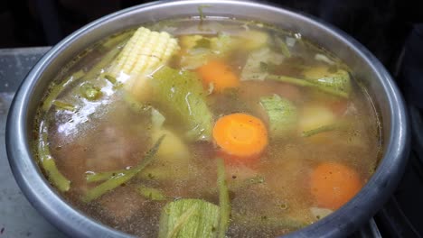 steaming food vegetable soup in hot bowl