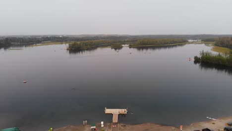 4K-Drone-Video-of-Swimmers-and-Paddle-Boarders-on-Cushman-Lake-in-Fairbanks,-AK-during-Summer-Day-1