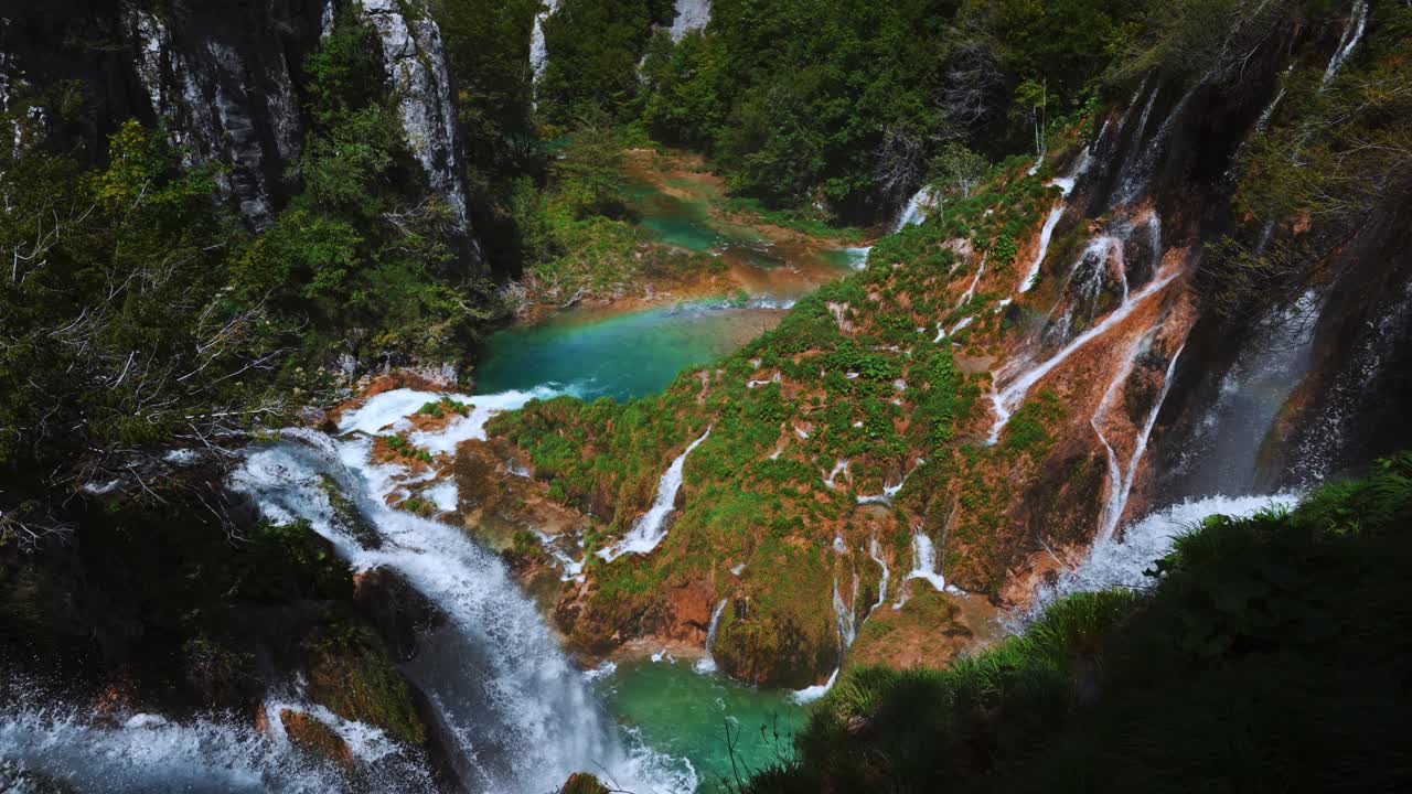 Scenic landscape with waterfalls, rainbow, lake and cliffs at Plitvice Lakes National Park, Croatia