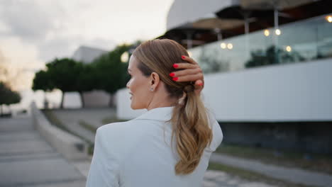 relaxed woman enjoy promenade at evening city close up. lady walking modern town