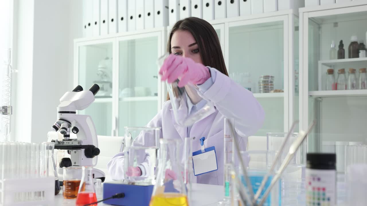 Female Scientist Conducting Chemical Experiment in Laboratory