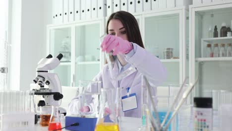 female scientist conducting chemical experiment in laboratory