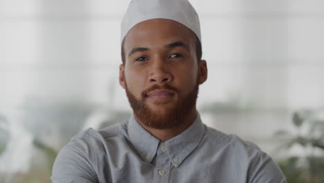 portrait young successful muslim businessman arms crossed looking confident mixed race entrepreneur enjoying professional lifestyle wearing kufi hat slow motion