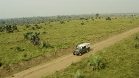 ambulance rushes to scene in africa along a dirt road in vast savannah