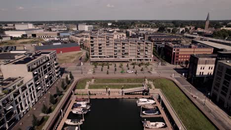 backwards aerial movement revealing the wider urban neighbourhood noorderhaven surrounding the pleasure boat port on river ijssel