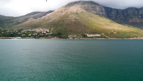 A-quiet-ocean-bay-with-a-hill-and-town-visible-in-the-distance