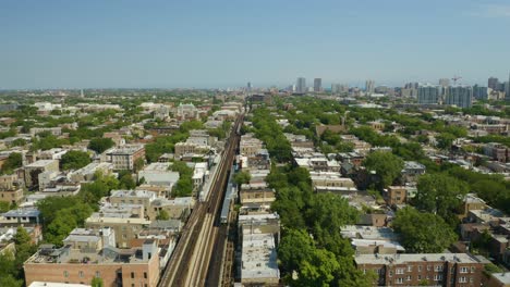 cta train stops at station on elevated tracks during summer in urban neighborhood