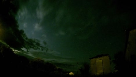 lapso de noche - estrellas, nubes, campo y edificio abandonado