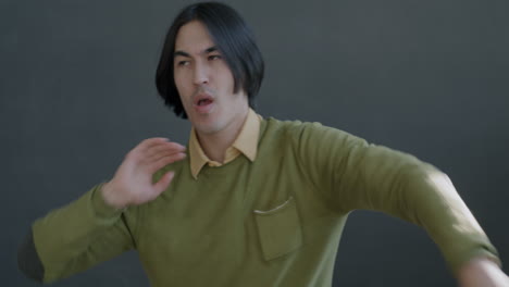 man dancing in a green sweater
