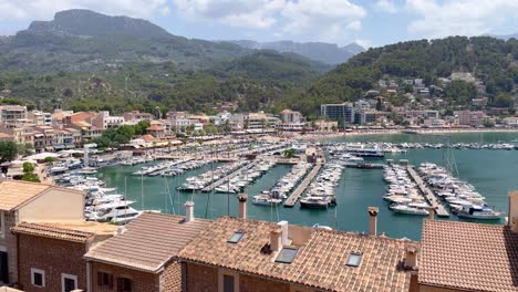 cityscape view of port de soller with harbour and mountains on majorca