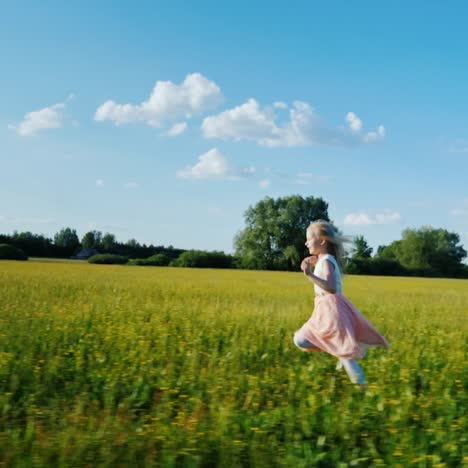 a 6 year old girl in a pink dress runs across the field with yellow flowers