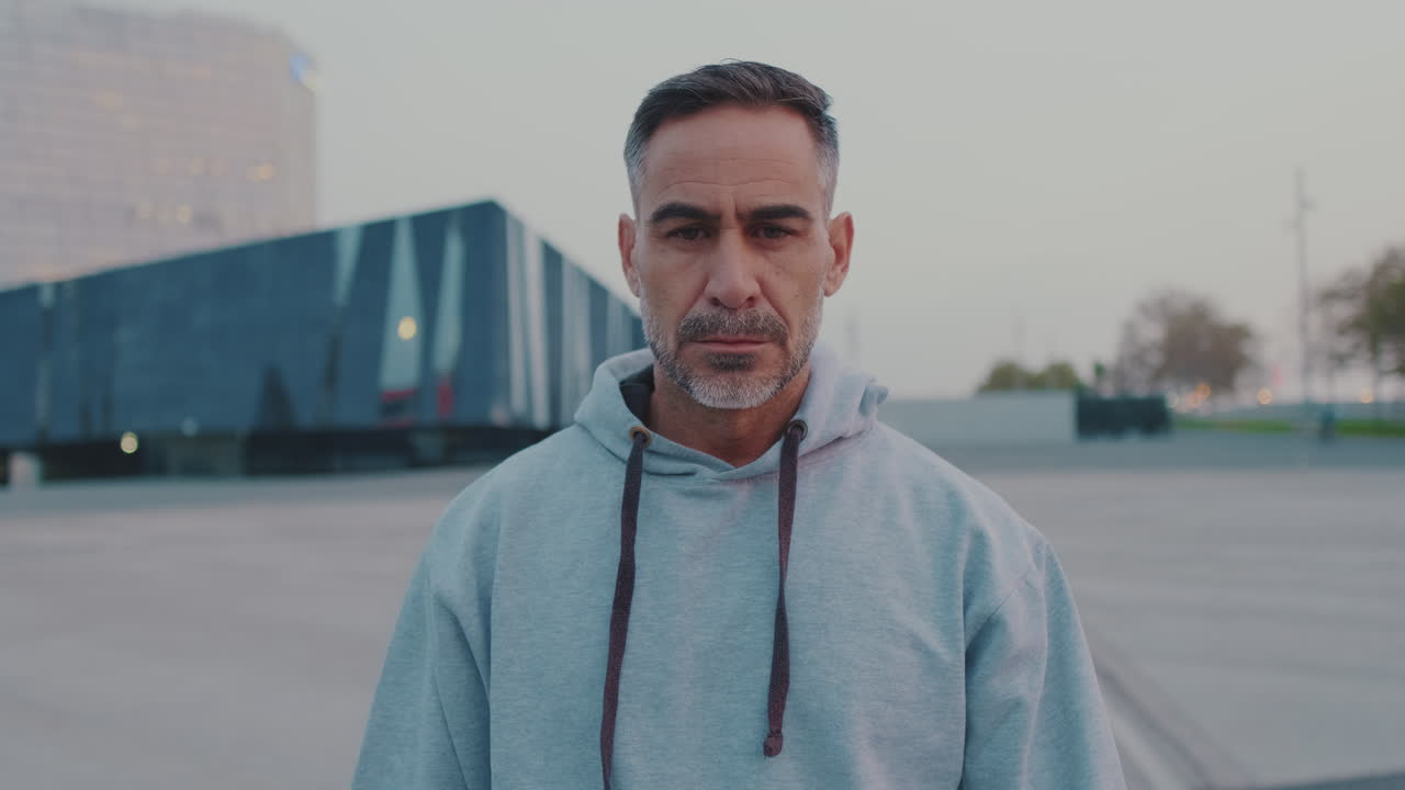 Portrait of a man in a gray hoodie