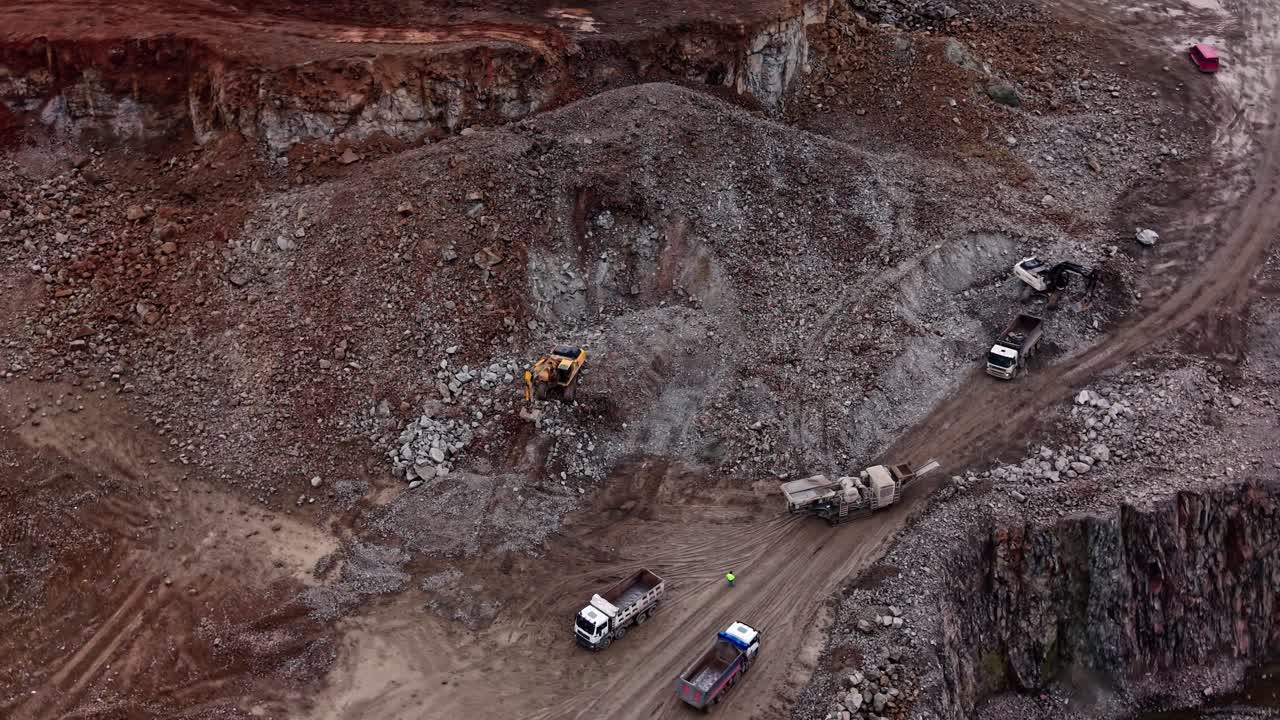 Granite extraction in quarry with machinery at work