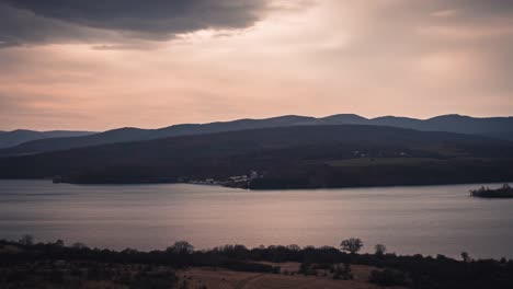 A-Mesmerizing-Timelapse-of-the-Changing-Hues-and-Serene-Beauty-of-a-Sunset-Reflected-on-a-Tranquil-Lake