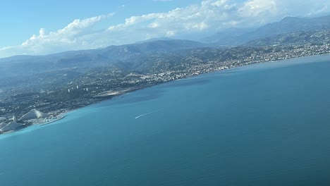 panoramic view of the french riviera from an airplane cabin in a right turn to nice airport