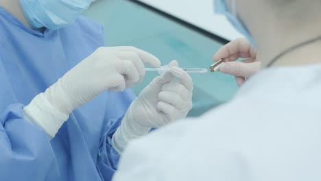 doctor filling syringe with medication in the hospital, closeup. vaccination and immunization. anesthesia