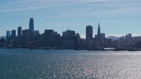 drone aerial view of downtown san francisco in mid day over the bay