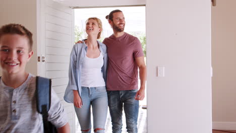 family opening door and walking in empty lounge of new home