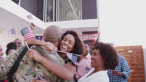 black family running out of their house to greet a soldier returning home