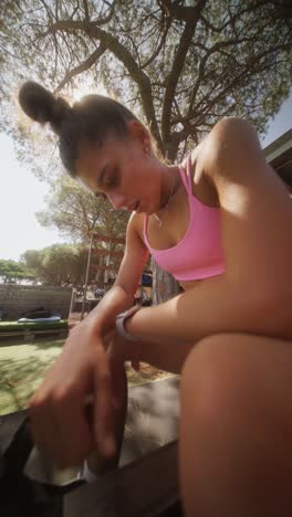 young woman in sportswear resting outdoors on a sunny day