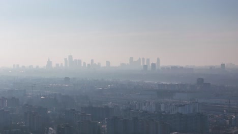 silhouette of warsaw downtown under a cloud of fog. aerial ascent