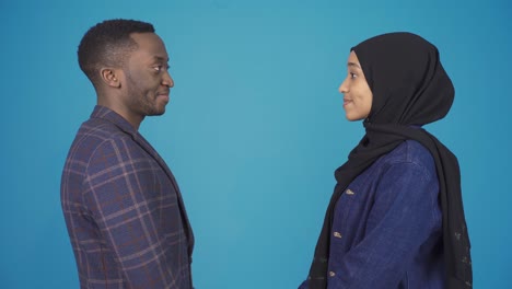 African-happy-positive-muslim-couple-smiling-and-looking-at-camera.