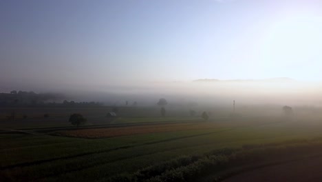 tuscany italy countryside in the morning with heavy fog, aerial drone pan-right reveal shot