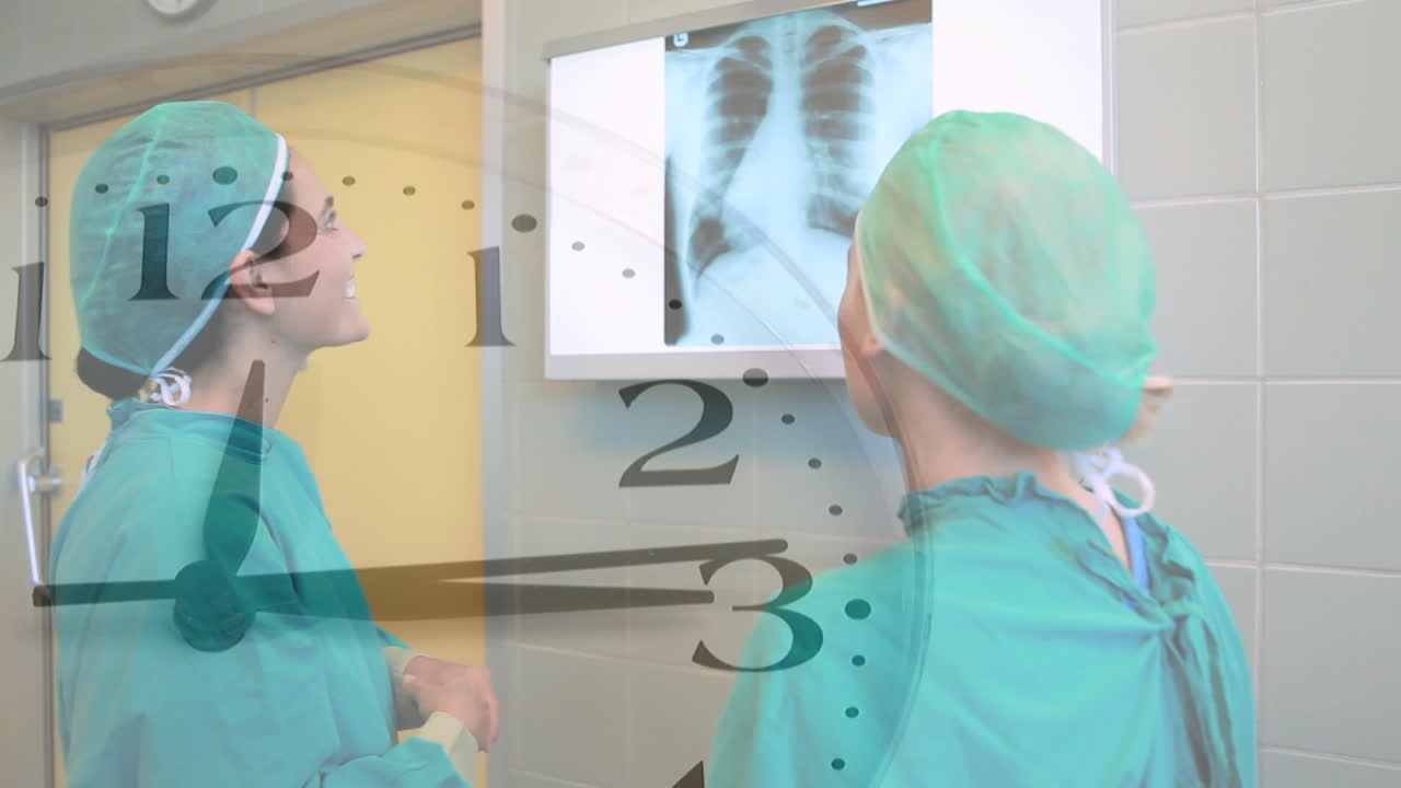 Animation of ticking clock over two diverse female surgeons discussing over x-ray report at hospital