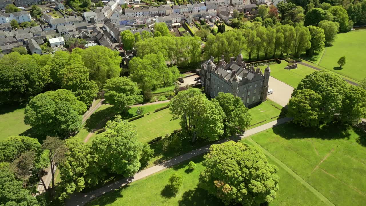Wide reversing aerial video of Glenarm Castle and Grounds, in Glenarm, County Antrim, Northern Ireland, UK on a bright and sunny day. Filmed in 4K, 60FPS and with Rec709 color.