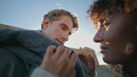young pair flirting evening coast closeup. relaxed couple touching each other