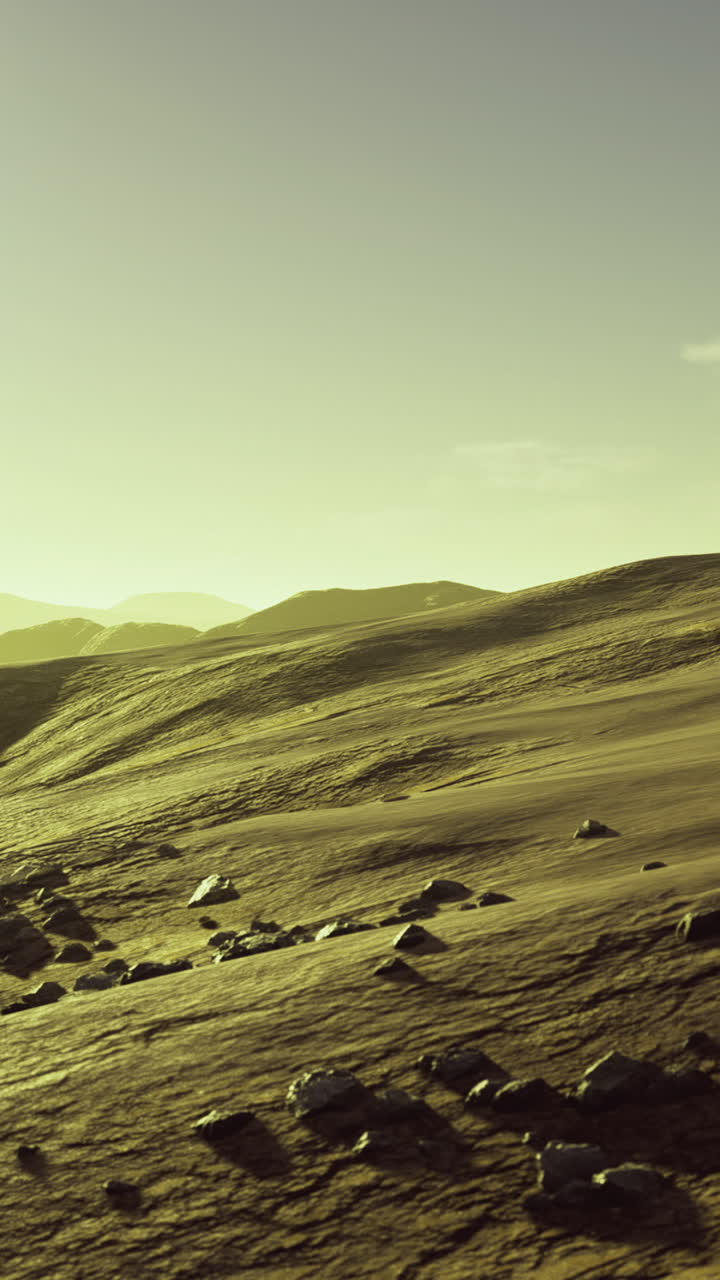 Expansive golden landscape with distant mountains under a bright sky