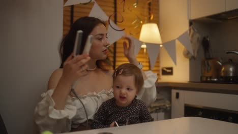 mother styling daughter's hair at a birthday party