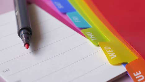 colorful weekly planner with pen