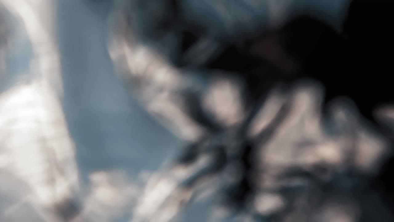 Spinning shot: Blue sky with beautiful textured clouds and sun light rays shining through on a sunny summer day