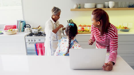 happy family using laptop in kitchen worktop 4k