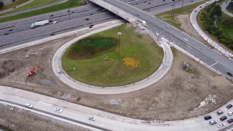 Highway-construction-of-overpass-bridge-and-ramps-with-busy-freeway-traffic