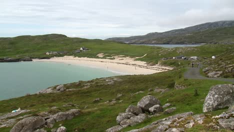 a shot of the beach at hushinish and the surrounding area with some cyclists biking on the isle of harris