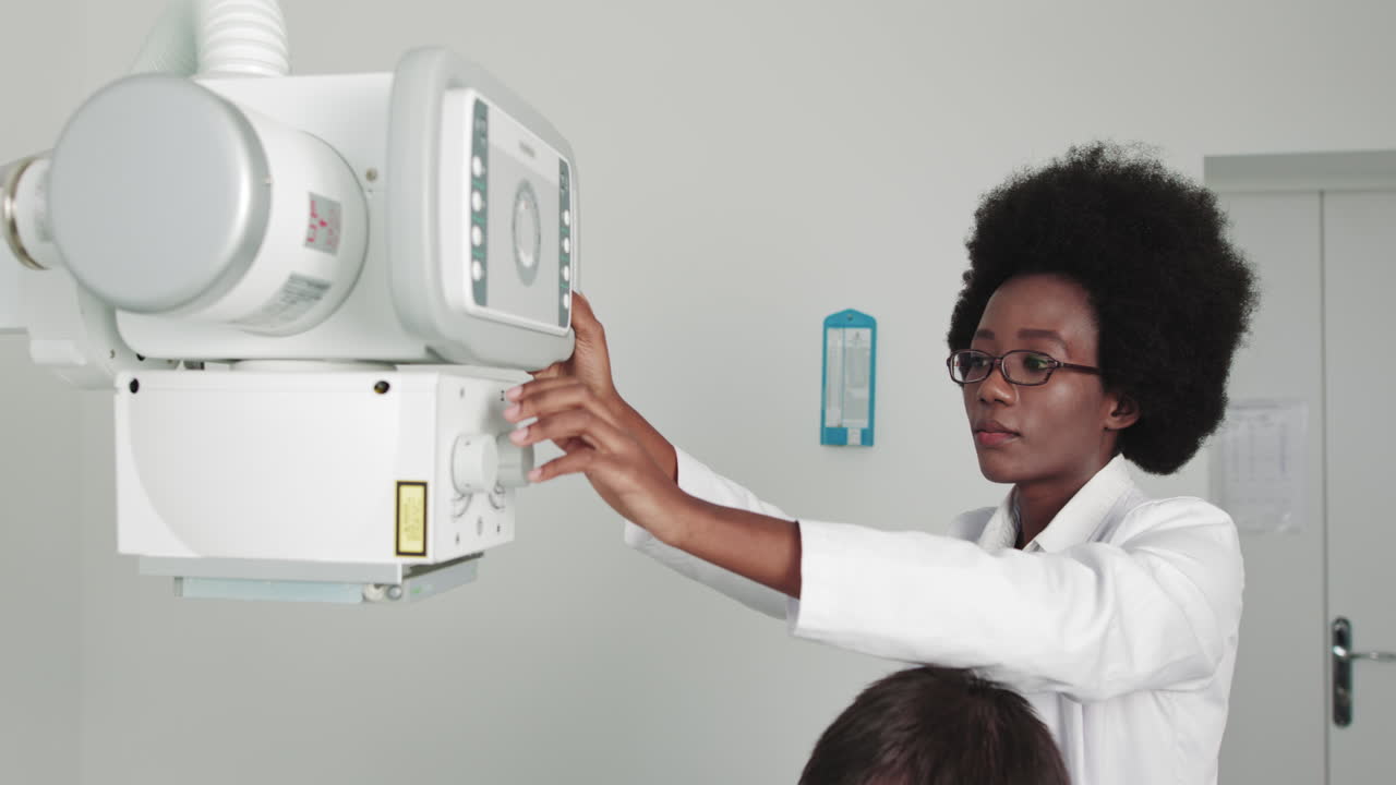 In the hospital female technician adjusts xray scanner machine modern hospital with technologically