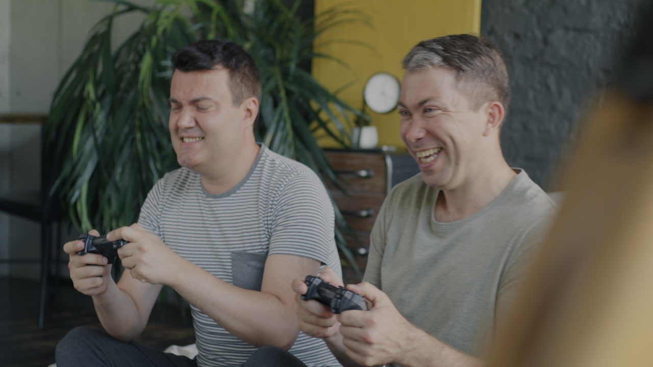 Two men playing video games at home