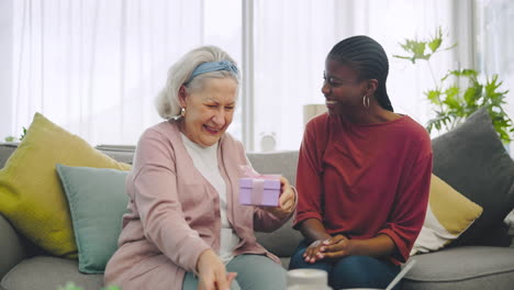 happy, gift and woman with senior patient