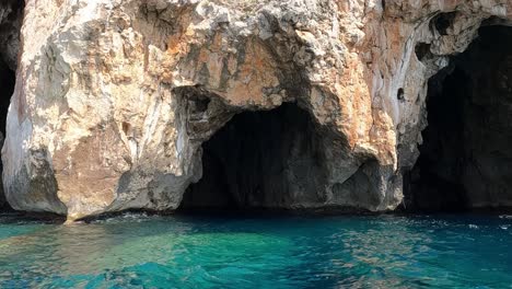 sideways boat point of view of vedusella or verdusella caves on adriatic side of mediterranean sea, italy