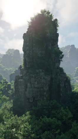 tall rocky mountain peak with green trees and foliage