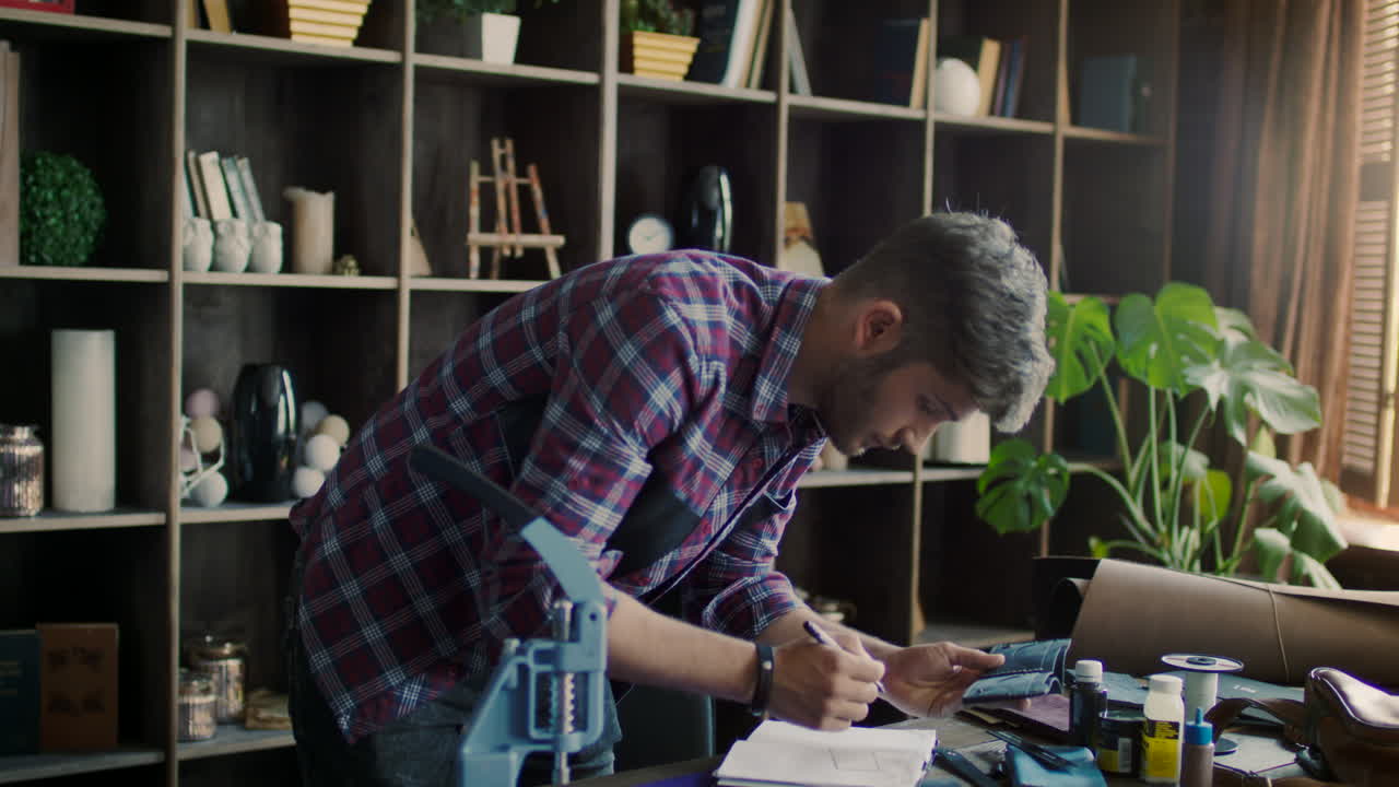 disegno di un lavoratore di pelle. disegnatore di articoli in pelle in officina